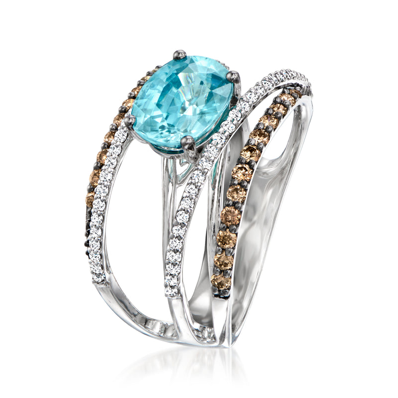 Blue topaz oval ring with prong-set center, white and brown diamond side bands