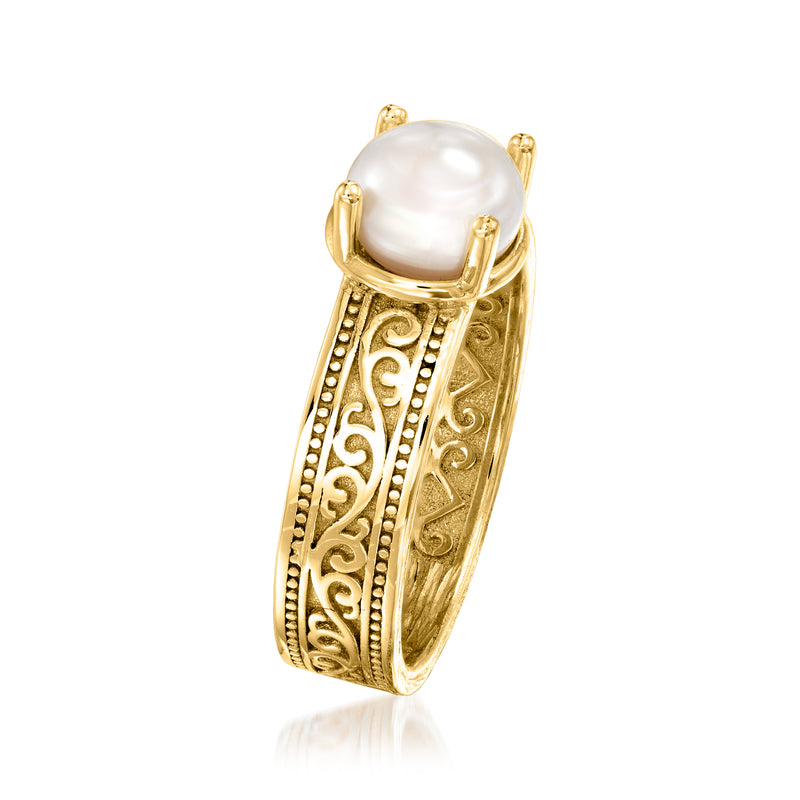 Gold-tone scrollwork ring with round white pearl on openwork band, side view