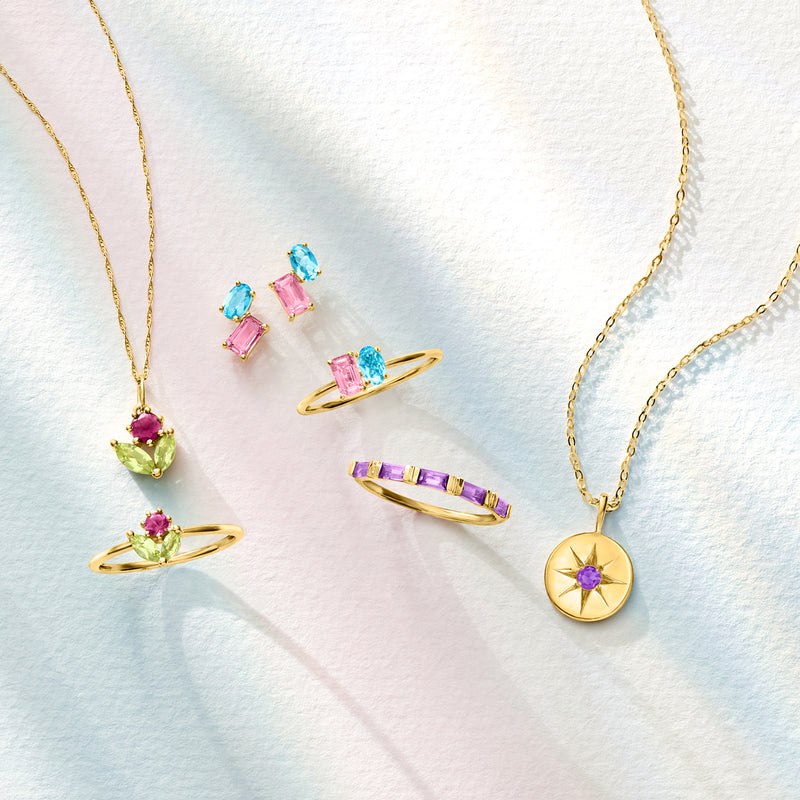 Gold chain necklace with colorful gemstone pendants, including pink, blue, and purple stones