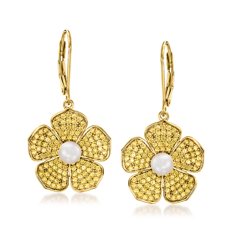 Gold flower drop earrings with white pearl centers, leverback closures