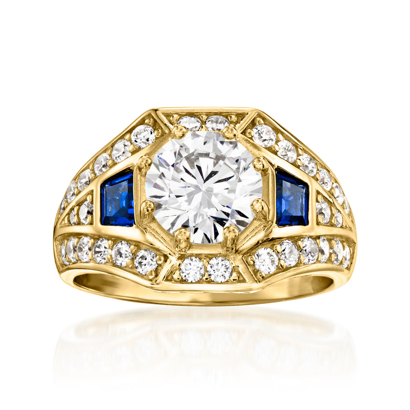 Gold-tone ring with large clear center stone, blue side stones, and round clear accents
