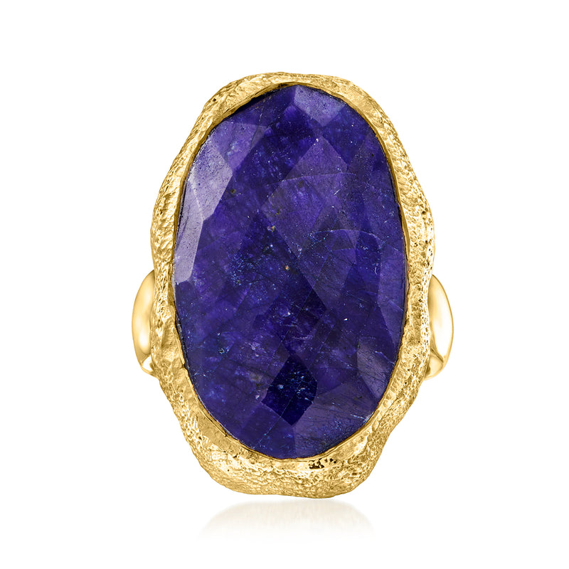 Gold sapphire ring with oval deep-blue gemstone in textured gold bezel