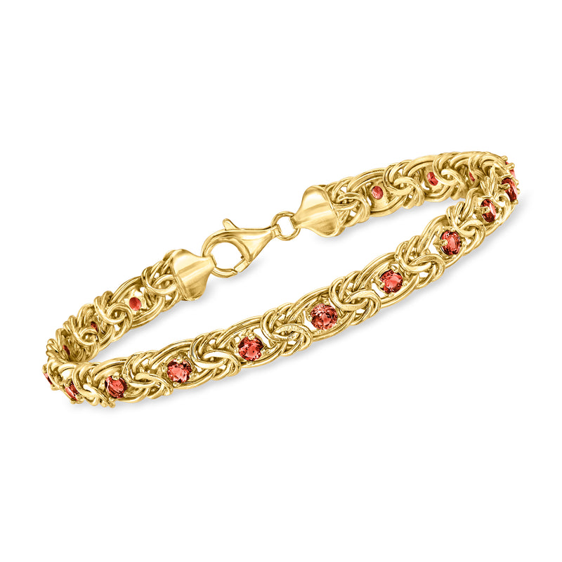 Gold Byzantine bracelet with red garnet-style stones and braided link design