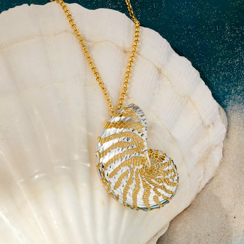 Seashell pendant necklace with gold-tone ridged swirl and silver stripe pattern