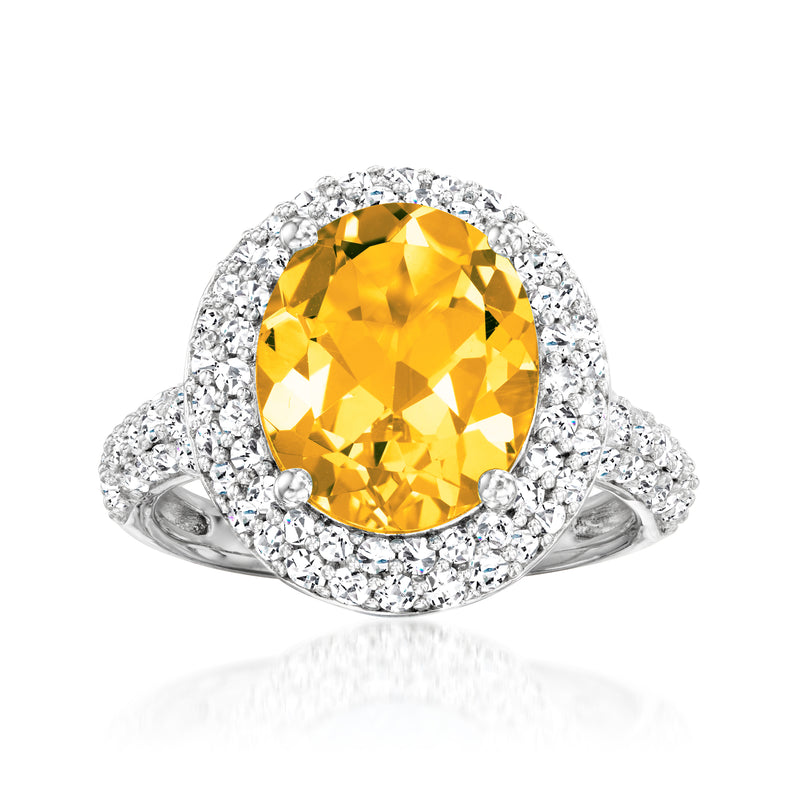 Sterling silver citrine ring with oval yellow gemstone and halo of white topaz stones