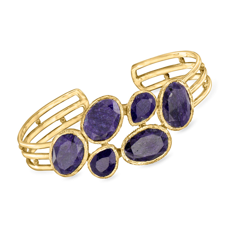 Gold over sterling cuff bracelet with purple oval sapphire stones, open-work design