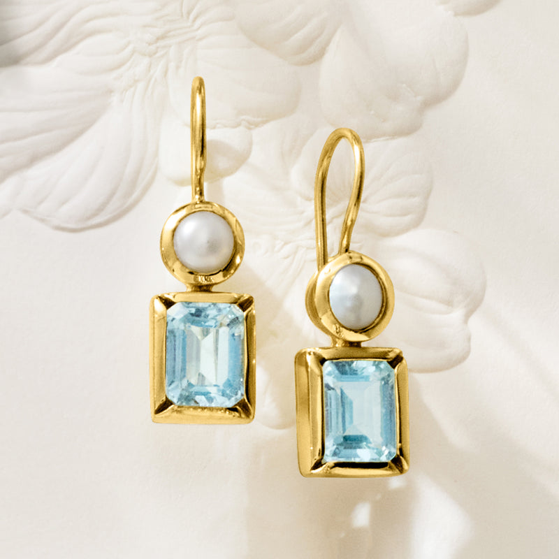 Gold drop earrings with round white cultured pearl and square sky blue topaz detail