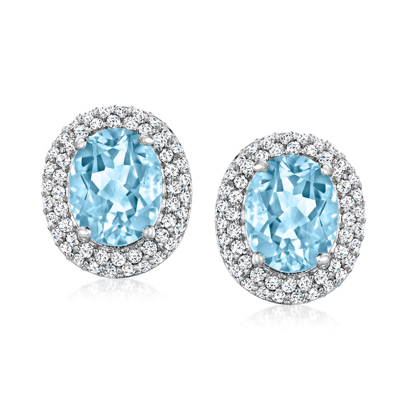 Sky blue and white topaz stud earrings in sterling silver, oval halo setting