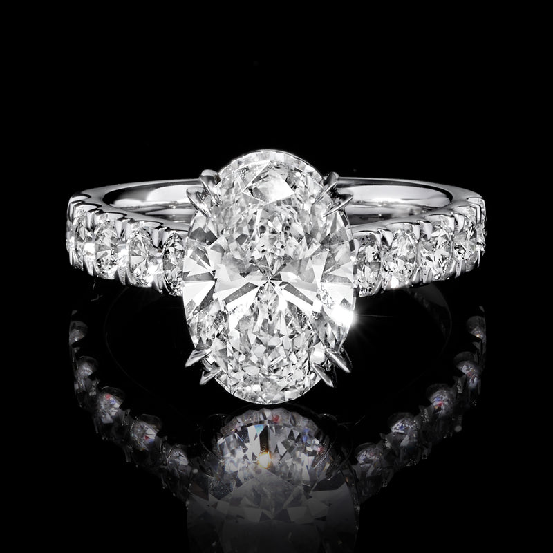 14kt white gold diamond ring with oval center flanked by round stones