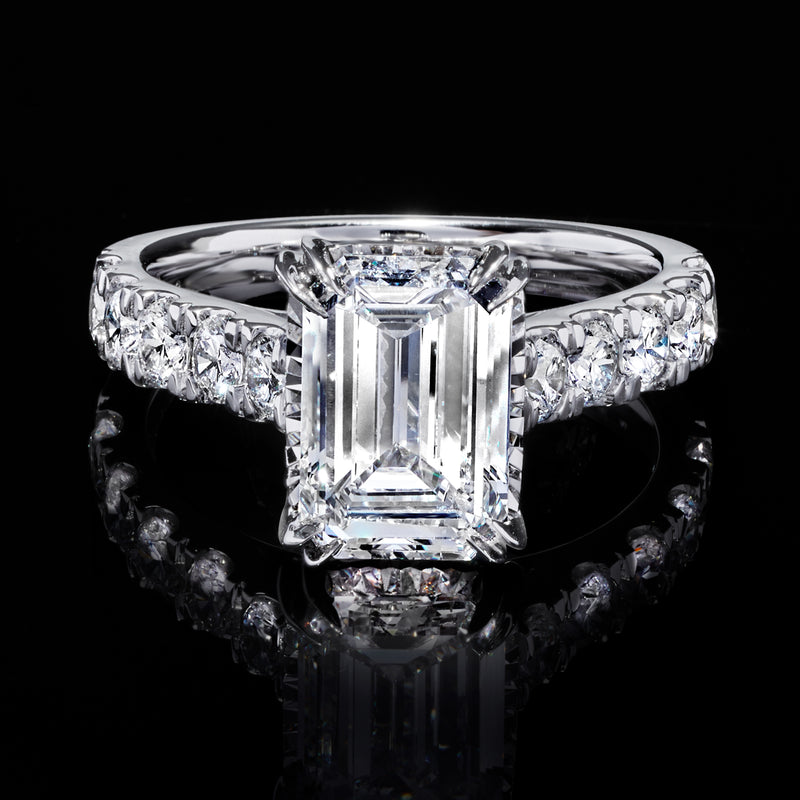 14kt white gold diamond ring with emerald-cut center and side stones