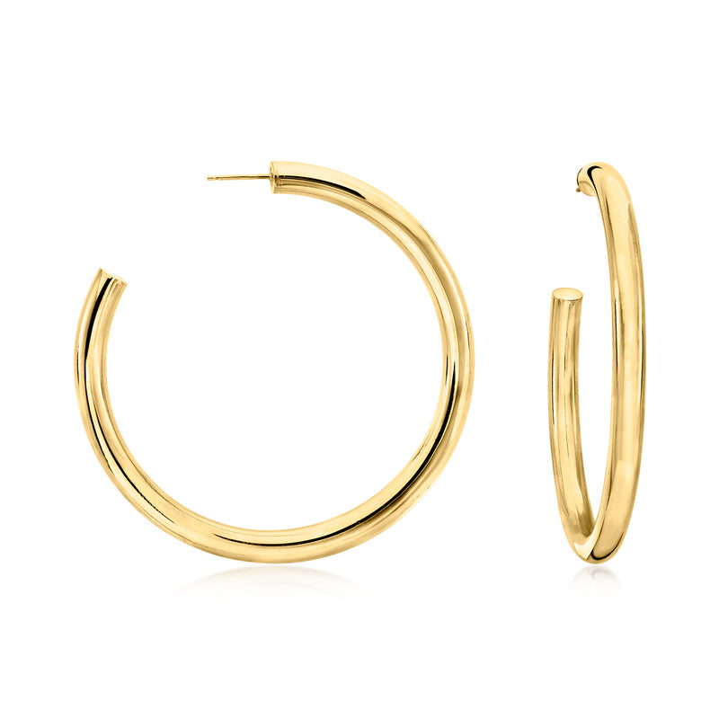 Gold-tone hoop earrings with smooth rounded profile, hinged post closure.