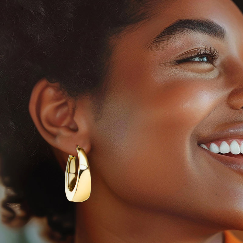 14kt yellow gold hoop earrings worn by model, smooth polished hoop