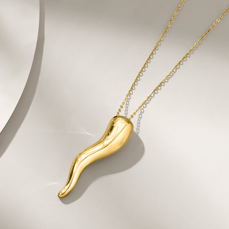 Yellow gold horn pendant necklace with curved horn pendant and chain links.