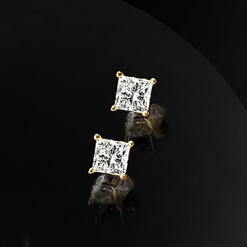 Princess-cut square diamond stud earrings in 14kt yellow gold, angled profile view