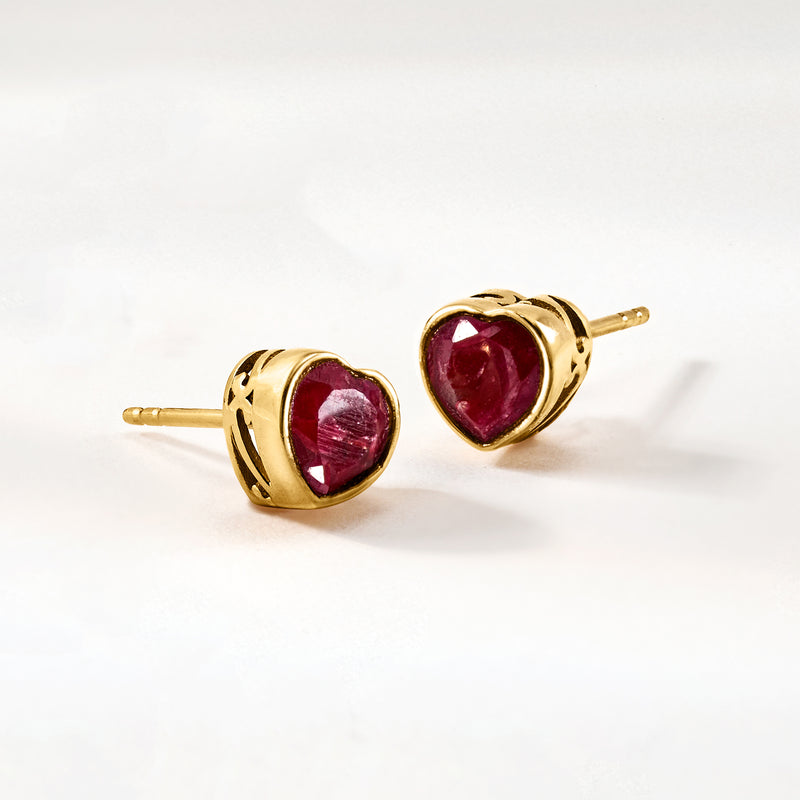 Pair of heart ruby stud earrings, gold-tone settings with deep red stones