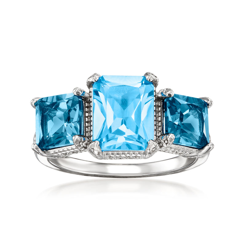 Sterling silver ring with three blue topaz stones; large center cushion, white zircon accents