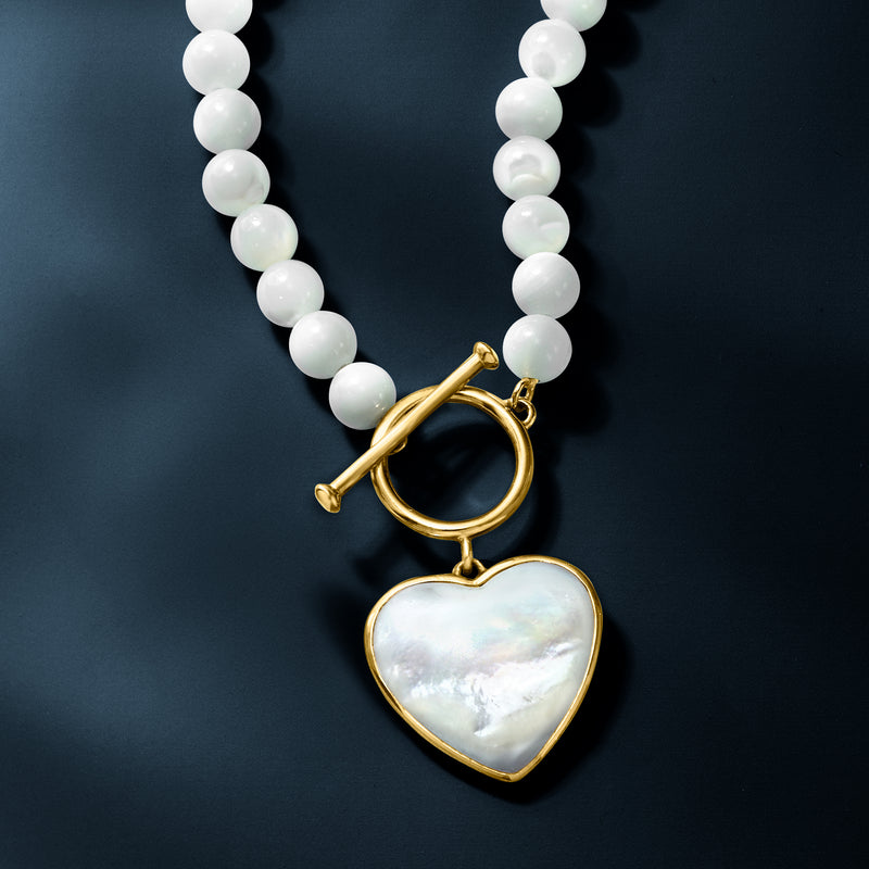 White bead strand necklace with gold toggle and mother-of-pearl heart drop