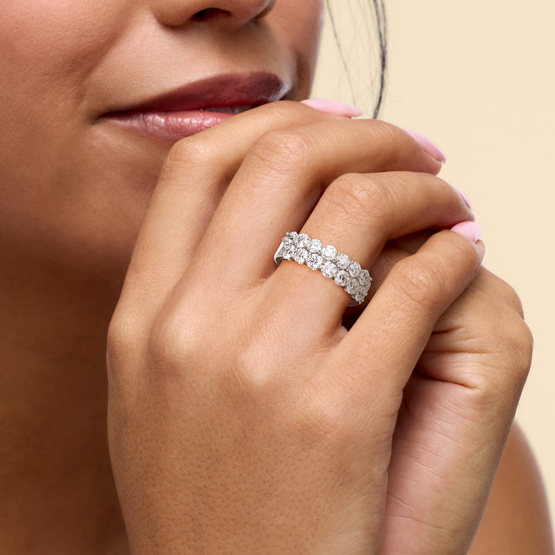 White gold two-row diamond ring on hand with round stones across the band