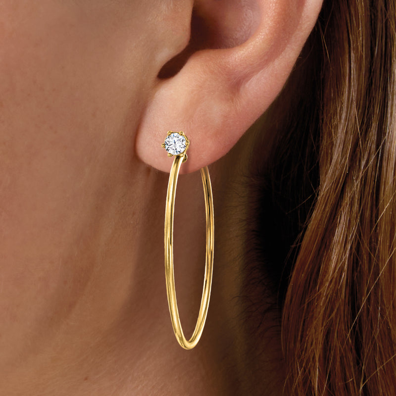 Gold hoop earrings with clear round CZ stud on top, worn on ear