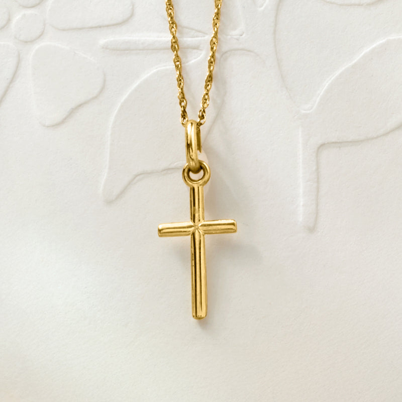 Yellow gold cross pendant necklace with polished loop bail and vertical cross charm