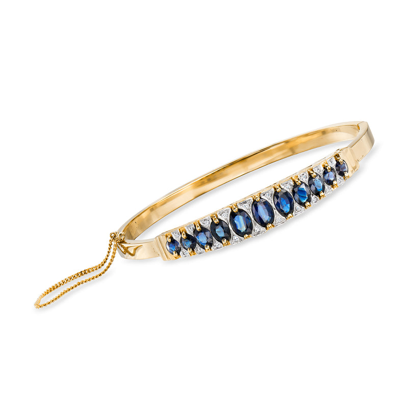14kt yellow gold bangle bracelet with oval blue sapphire row and diamond accents