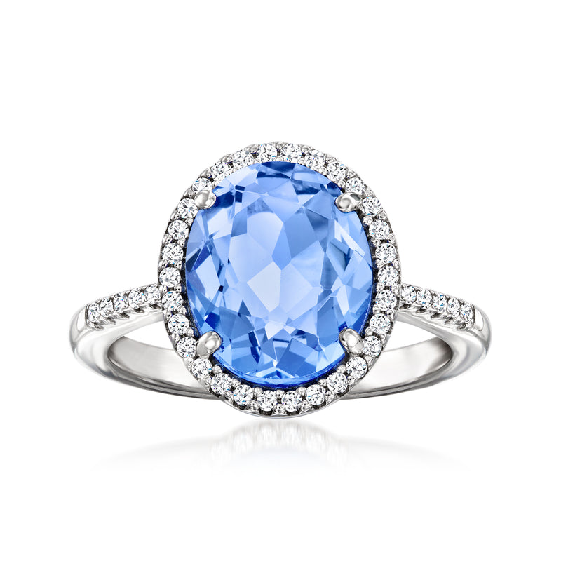 Sterling silver ring with oval light-blue simulated sapphire and CZ halo split band