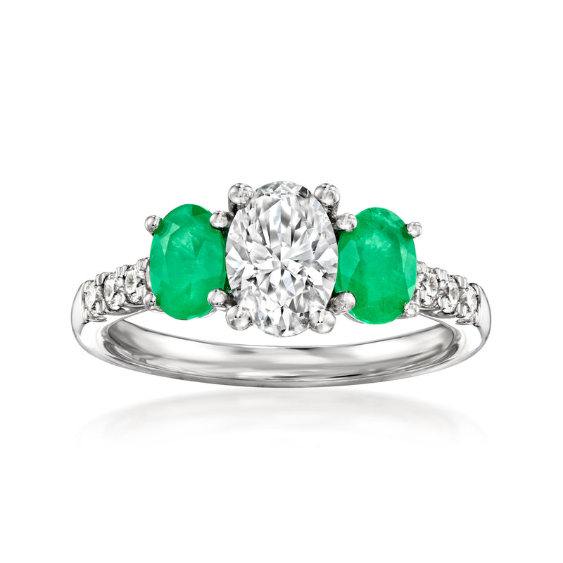 14kt white gold ring with center round diamond and two green emerald stones