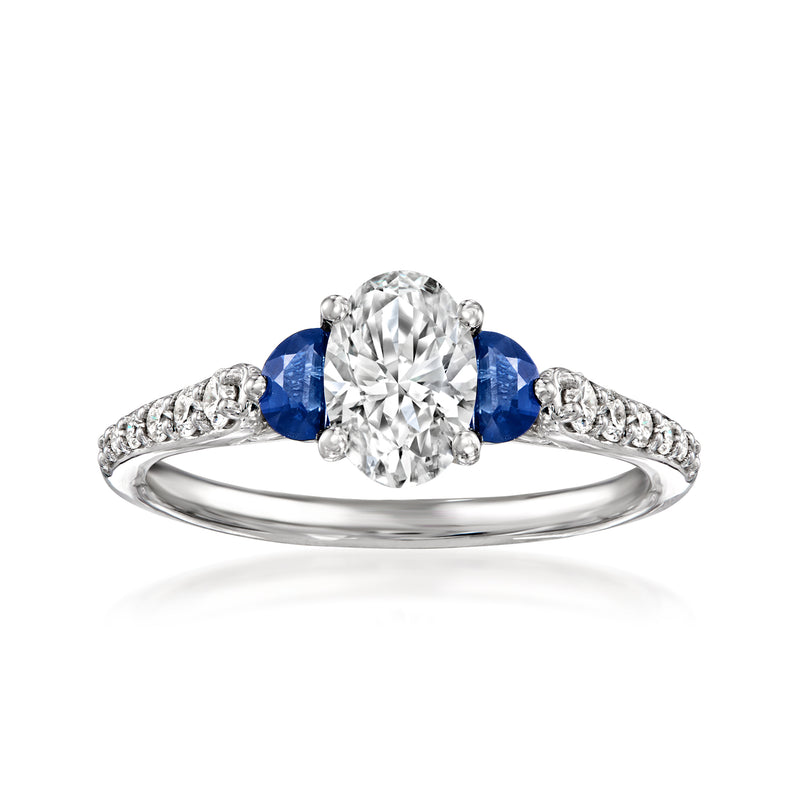 14kt white gold ring with oval diamond center, blue sapphire accents, small diamond pave