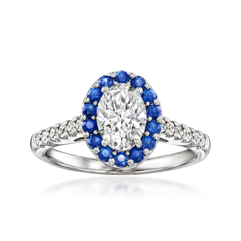 14kt white gold ring with round diamond center, blue sapphire halo, and diamond shoulders