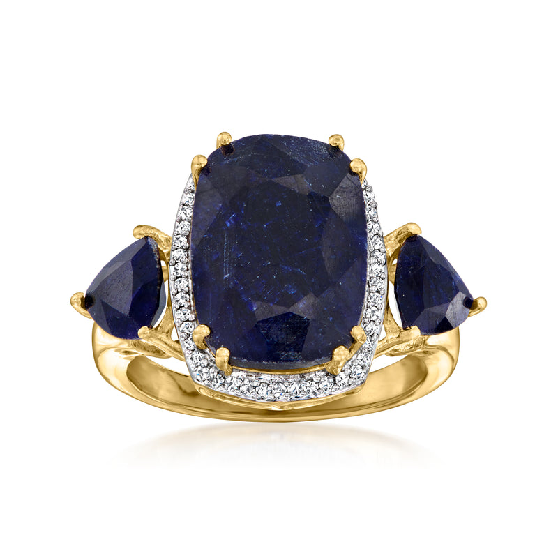 Oval sapphire and diamond halo ring in gold with three blue side stones