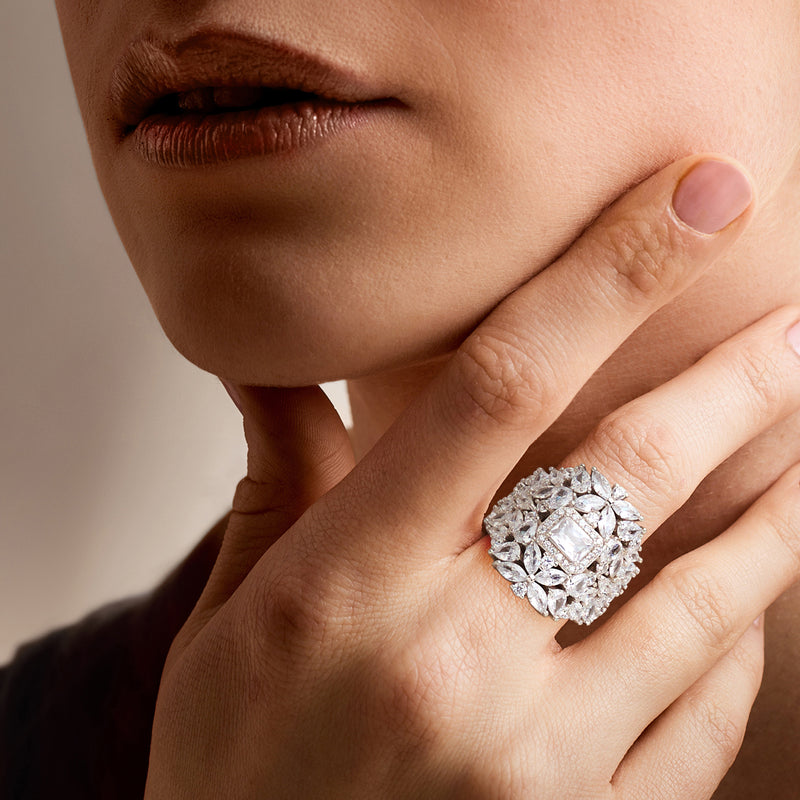 Sterling silver CZ floral ring on hand, round halo stones around rectangular center
