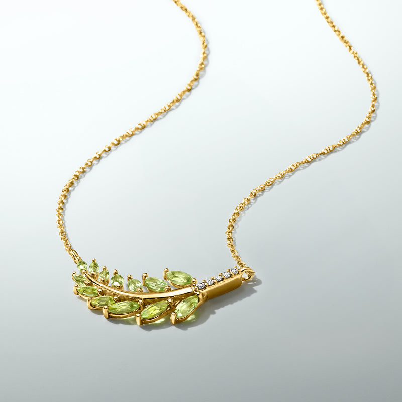 Gold chain with leaf-shaped peridot and diamond pendant, side view