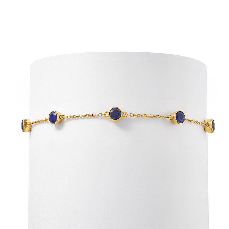 Gold over sterling bracelet with five round blue sapphire bezel-set stations