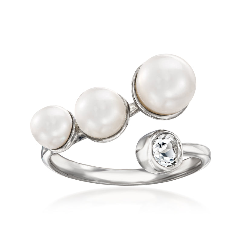Sterling silver ring with three white cultured pearls and round white topaz