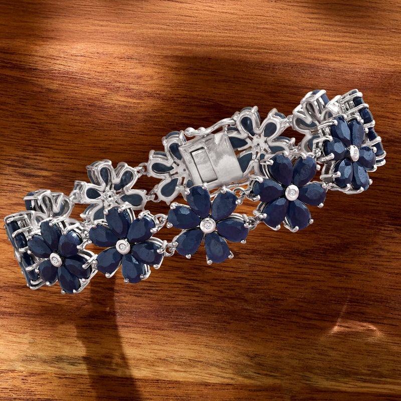 Sterling silver bracelet with linked blue flower clusters and small round diamond accents
