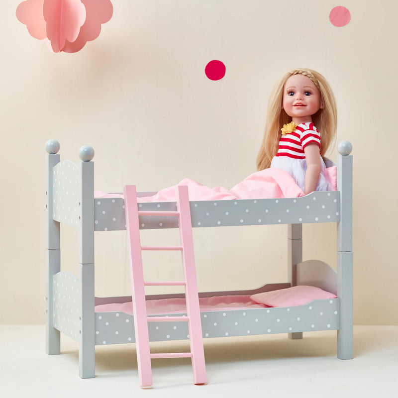 Child doll double bunk bed with light blue polka-dot panels and pink ladder, doll on top