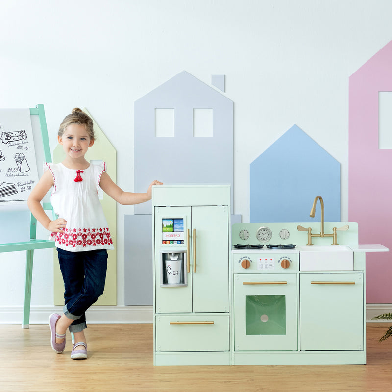 Mint and white modern play kitchen with gold accents, stove, sink, and oven door