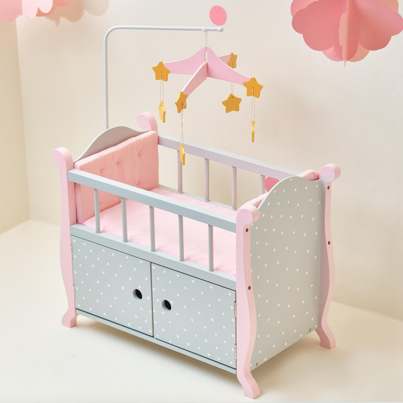 Child's gray and pink baby doll bed with star mobile and two front drawers