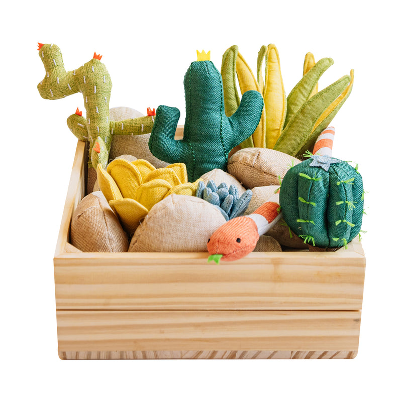 Wooden crate filled with plush succulent garden toys, including cactus shapes and a small critter