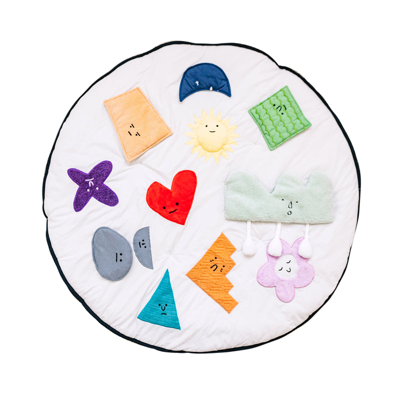 Round baby activity mat with colorful sewn felt shapes and smiling faces