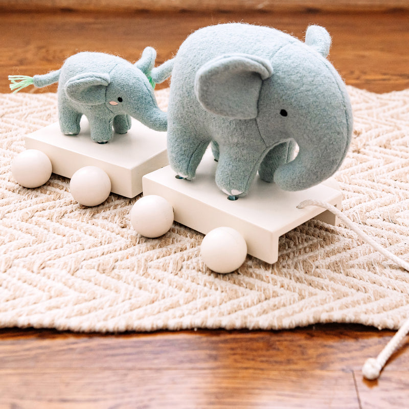 Plush elephant pull toy with rope and wooden bead wheels