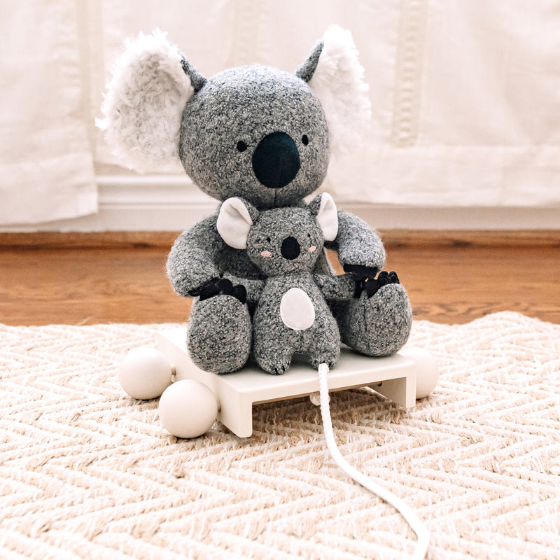 Gray plush koala pull toy with attached white pull cord.