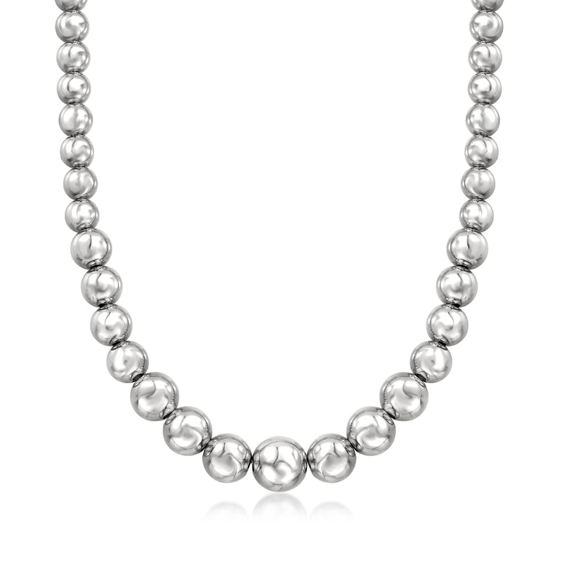 Sterling silver graduated bead necklace with round polished beads, close neckline view