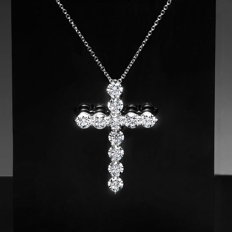 White gold diamond cross pendant necklace with round and oval stones