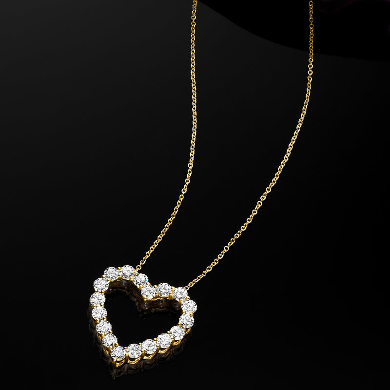 Heart-shaped diamond pendant necklace with round stones in 14k yellow gold chain