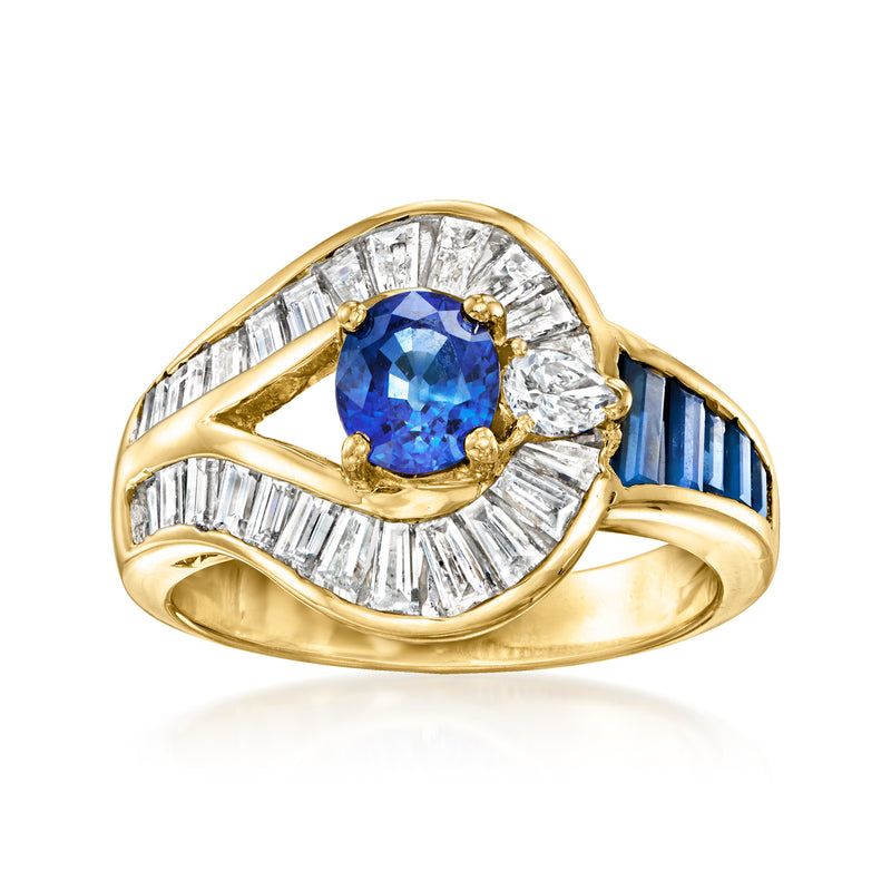 18k yellow gold ring with oval blue sapphire center, diamond halo and baguette accents