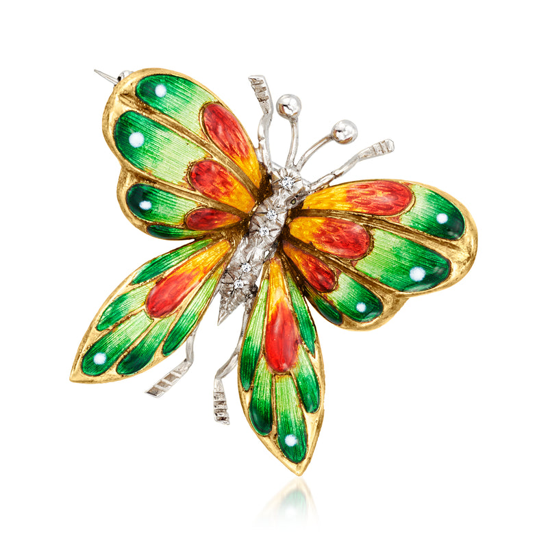 Butterfly enamel pin with green, red, and gold detailing and clear stone accents, two-tone gold back