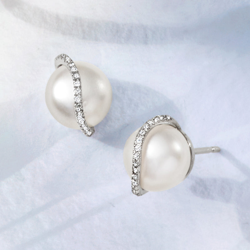 Sterling silver pearl post earrings with sparkling diamond swirl band