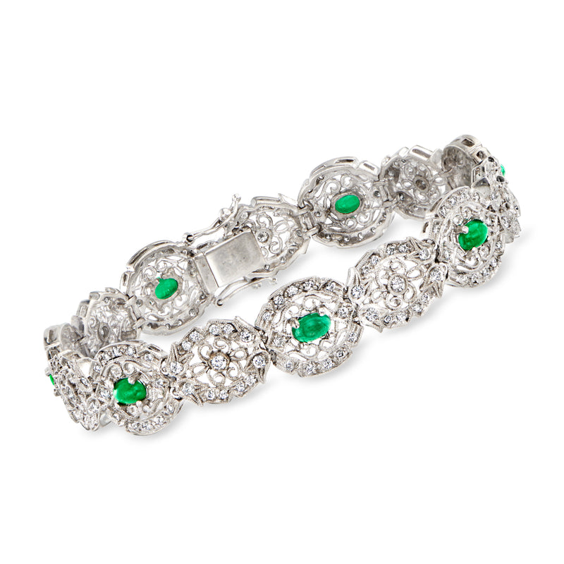 18kt white gold filigree bracelet with diamond clusters and green emerald stones