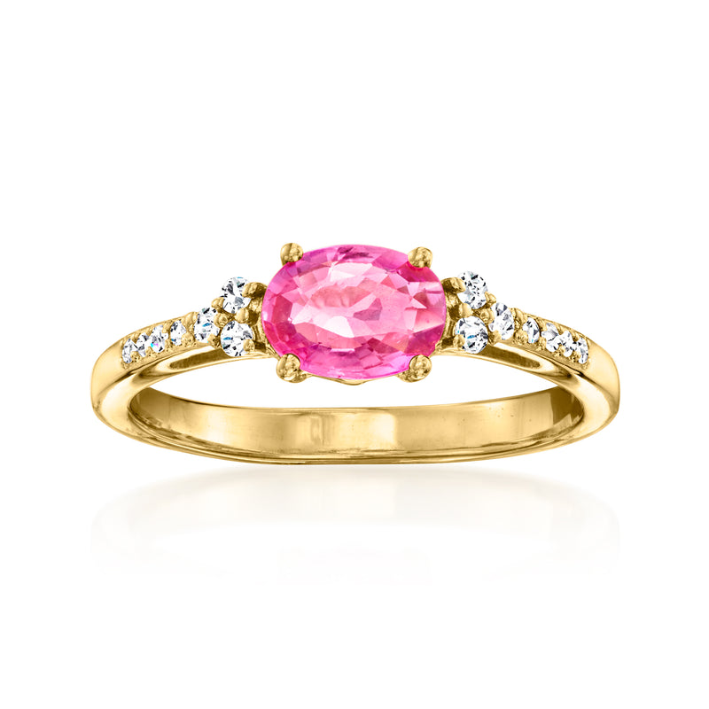 Gold ring with oval pink sapphire and small diamond side accents